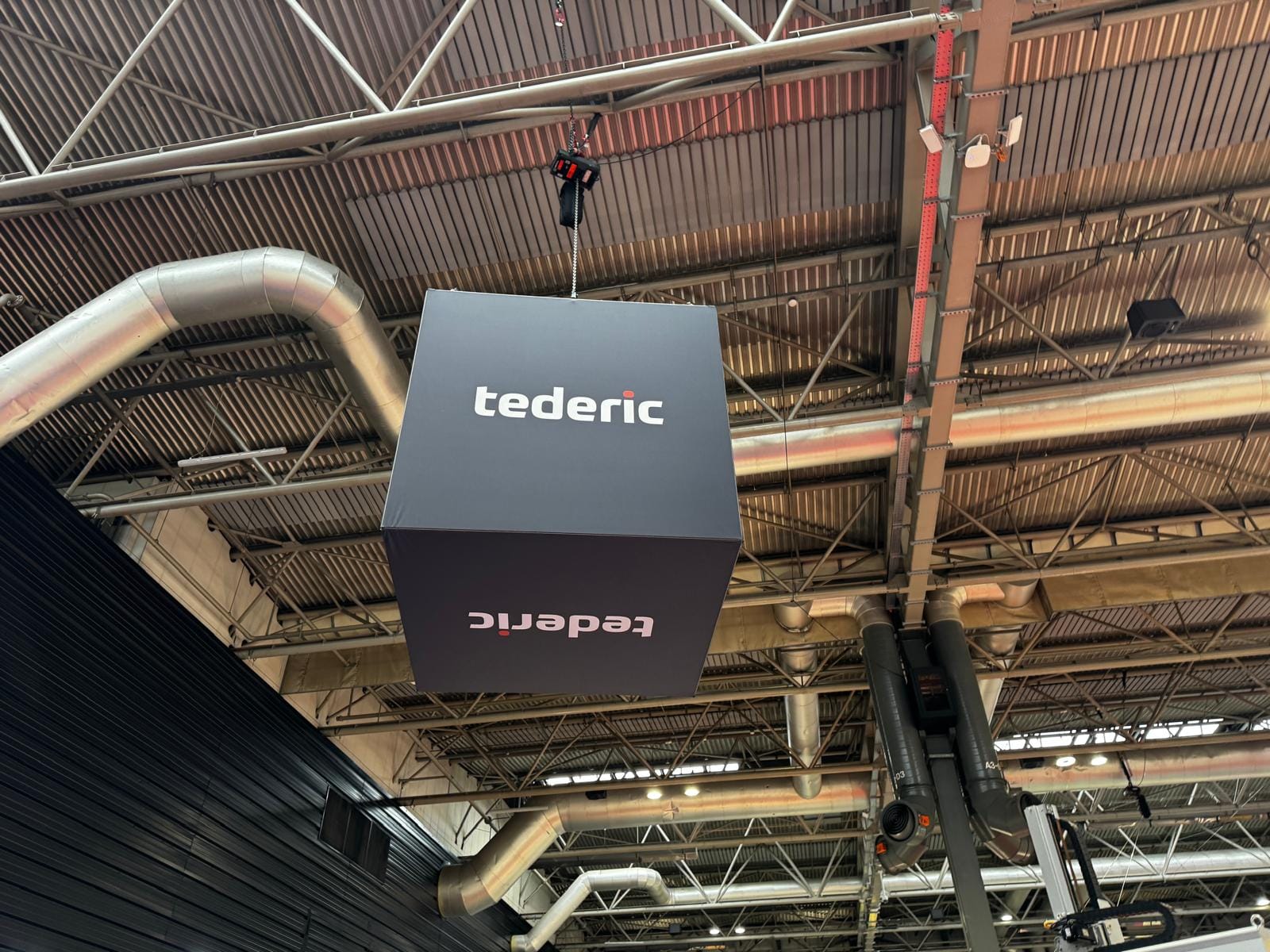 Tederic hanging branded media cube rigged above the stand at Interplas, NEC Birmingham