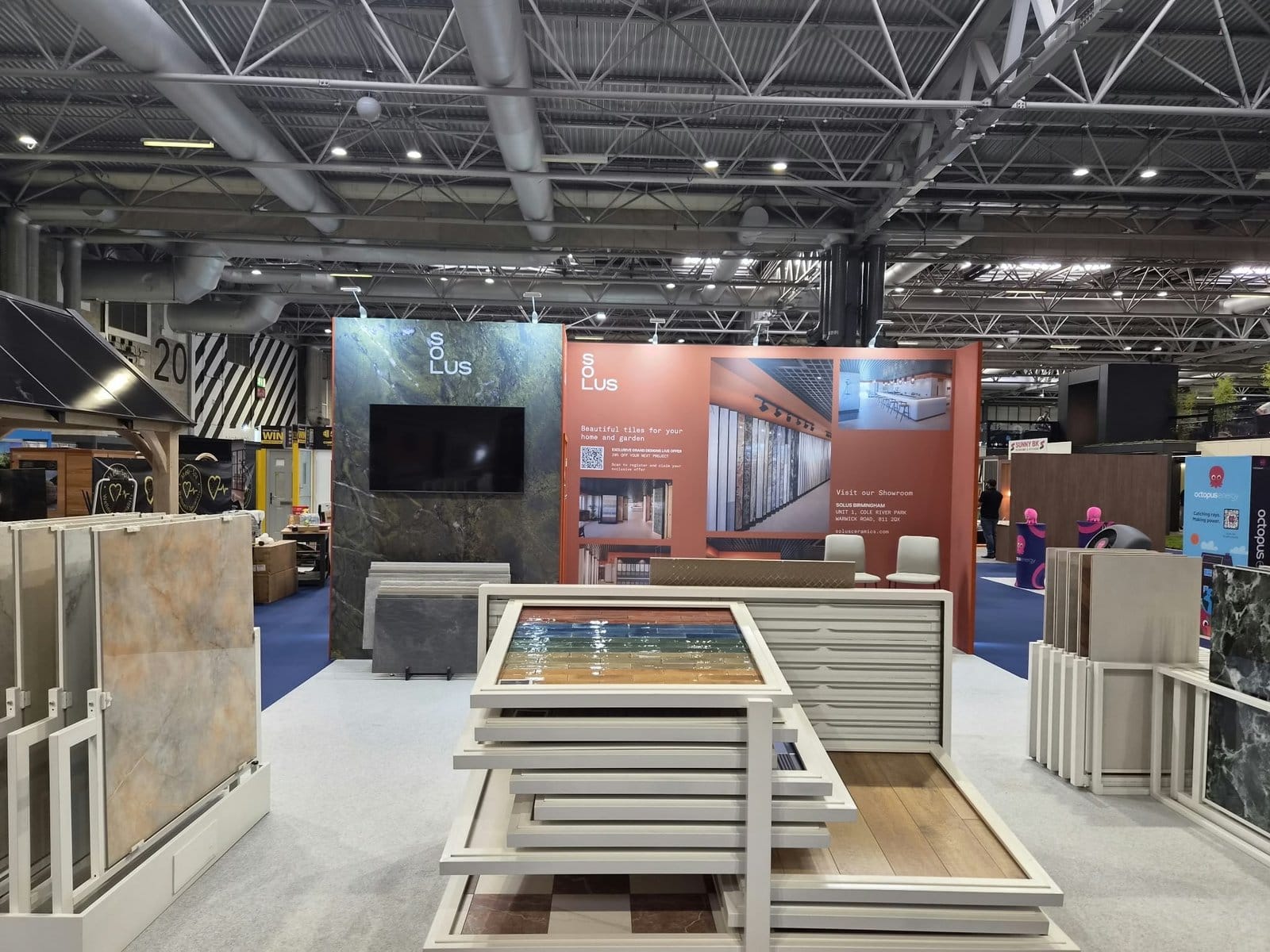 Graphic walls and wall-mounted TV on the Solus Ceramics stand at Grand Designs Live 2026